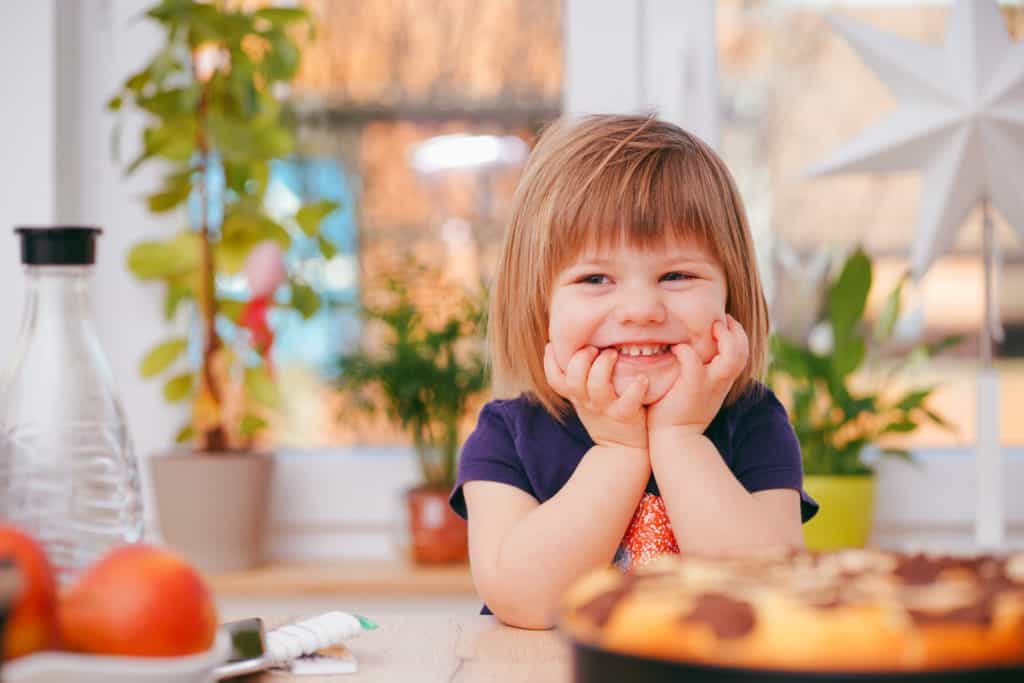 smiling toddler with a healthy appetite